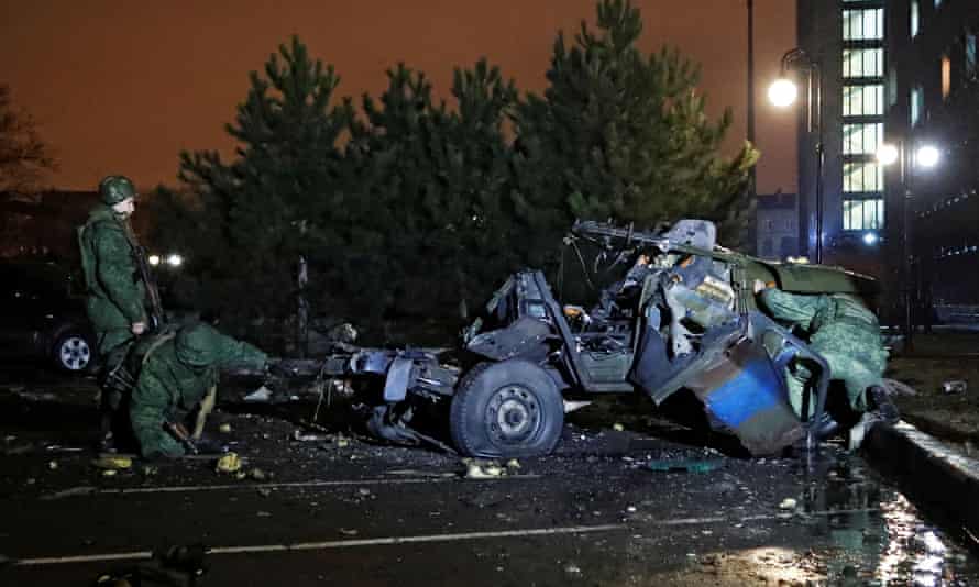 Soldiers inspect wrecked car