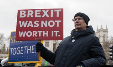 A pro-EU demonstrator holding a placard that reads: 'BREXIT WAS NOT WORTH IT.'