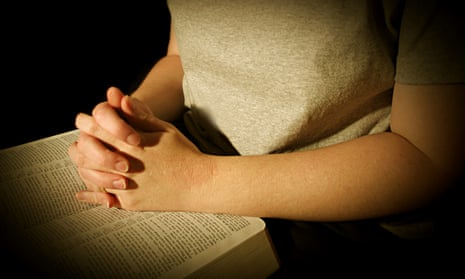 Woman Praying over Bible