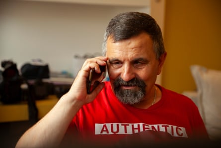Portrait of a man with a beard wearing a red T-shirt