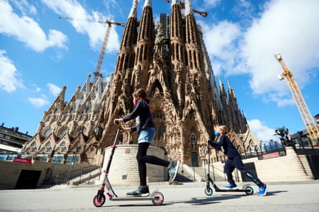 Two girls play in front of the Sagrada Familia in Barcelona