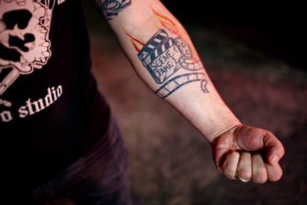 TM Garret shows a tattoo that represents his life after leaving the world of white supremacy.
