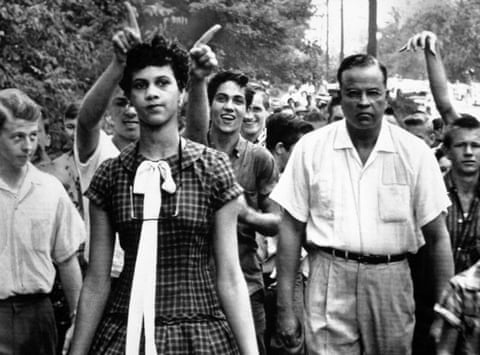 Dorothy Counts, 15, the first black student to attend Harding High School in Charlotte, North Carolina, is followed from school by shouting white students on Sept. 5, 1957. Dr. Edwin Tompkins, a family friend, escorted her. (AP Photo/Douglas Martin)