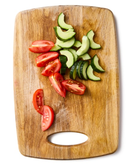 sliced tomato and cucumber on a chopping board