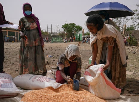 An aid worker distributes lentils in Mek’ele, the capital of Tigray.