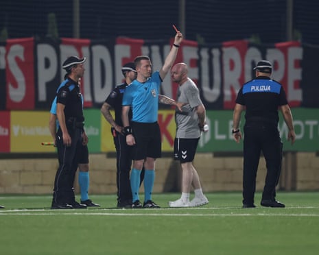 Referee Jeremy Muller shows a red card to a Hamrun Spartans official.