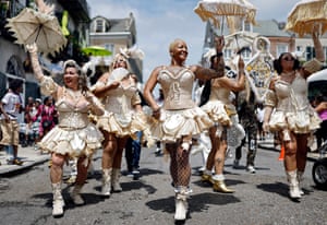 Members of the Mahogany Blue Baby Dolls march in the 25th Anniversary Satchmo Salute second line parade in New Orleans