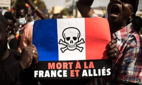 Demonstrators in Bamako hold a sign reading "Death to France and its allies", during a protest against sanctions imposed on Mali over delayed elections. 