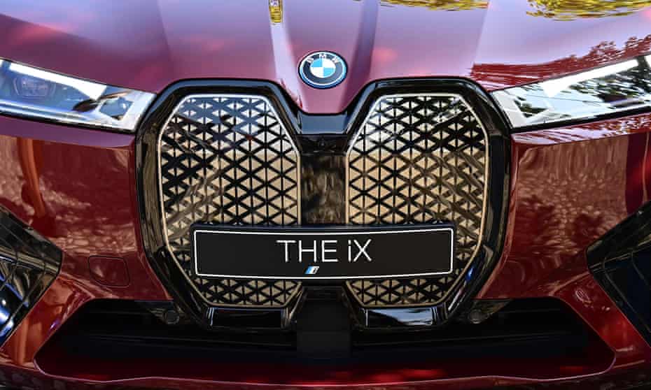 The company's logo is seen on the bonnet of a BMW iX electric vehicle