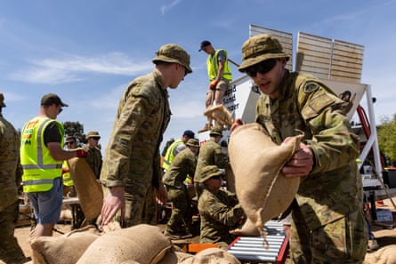 Avustralya savunma gücü üyeleri Pazartesi günü Shepparton'daki gösteri alanlarında kum torbaları hazırlıyor.
