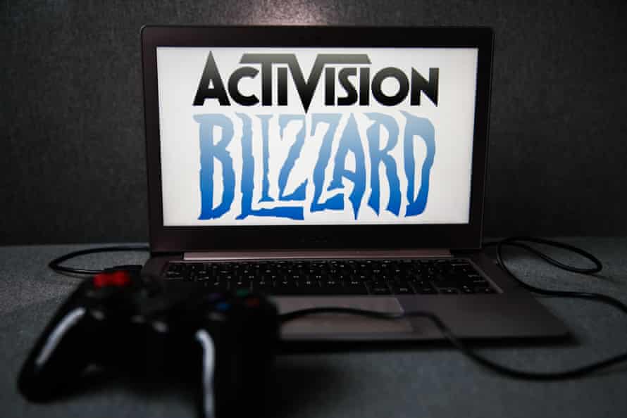 Activision Blizzard logo displayed on a laptop screen and a gamepad