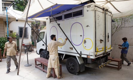 Artist Ali Salman Anchan paints the stories of flood survivors on an aid delivery truck in Sindh, Pakistan