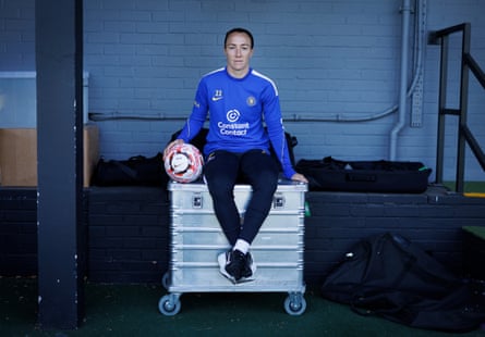 Lucy Bronze sits on a storage box at the training ground.