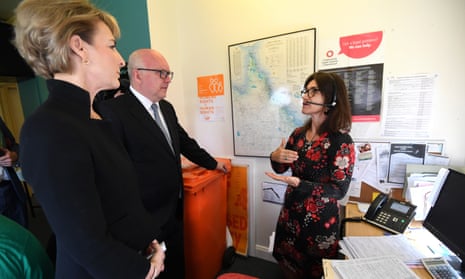 Federal Attorney-General George Brandis and Minister for Women Michaelia Cash (left) talk to helpline lawyer Julie Sarkozi as they visit a Women’s Legal Service centre in Brisbane, Monday, April 24, 2017