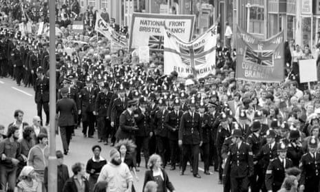 Police officers escort a National Front rally through Lewisham on 13 August 1977.