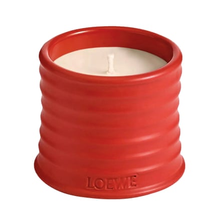 White candle in ribbed red holder