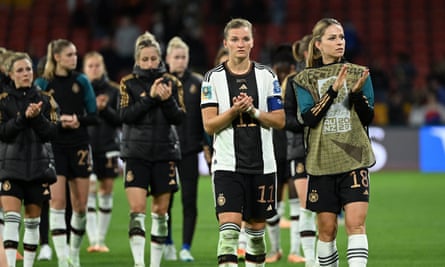 Alexandra Popp (centre) of Germany and her teammates react after their 1-1 draw against South Korea.