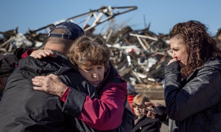 Local residents Darlene Easterwood and Tim Evans embrace after taking part in an outdoor Sunday service with members of First Christian Church and First Presbyterian Church in the aftermath of a tornado in Mayfield, Kentucky.