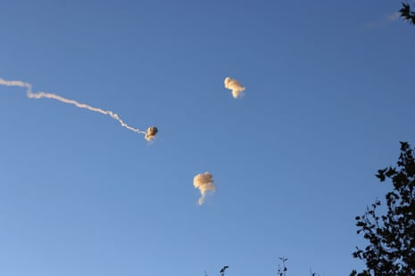 A picture taken from kibbutz HaGosherim in northern Israel shows rockets being fired from Lebanon being intercepted by Israel’s Iron Dome missile defence system.