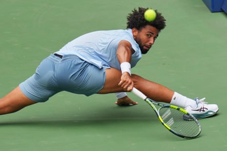 Arthur Fils of France lunges to return the ball to Stefanos Tsitsipas of Greece.