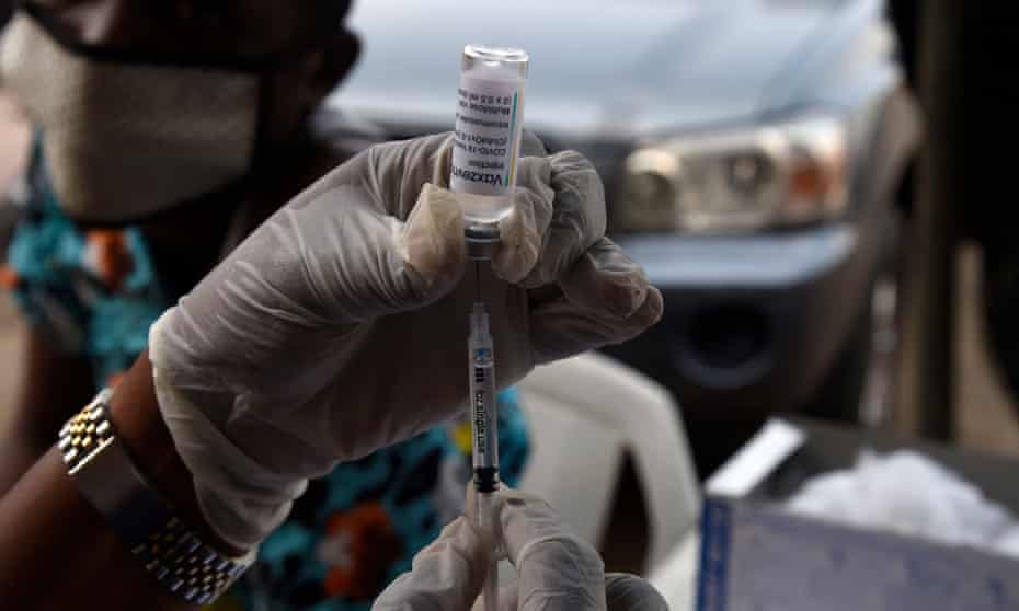 A health worker tries to load an Astrazeneca vaccine into a syringe at a mosque in Lagos, Nigeria.