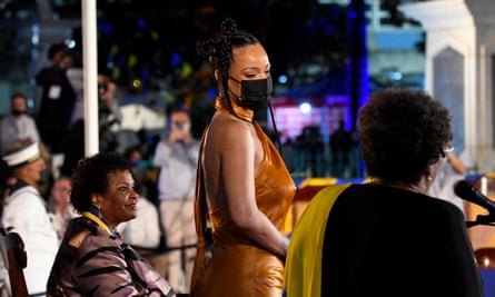 Rihanna (C) reacts after Mia Mottley (R) asked new president Sandra Mason (L) to make her the country’s 11th national hero.