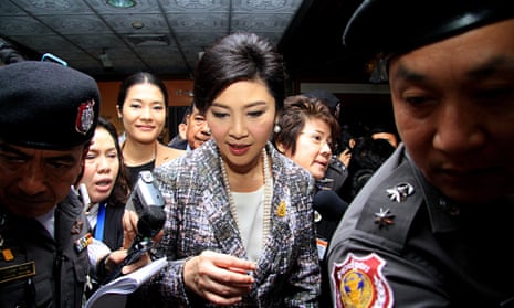 Yingluck Shinawatra leaves the final impeachment hearing at Parliament in Bangkok. The former prime minister now faces a court trial over a rice subsidy scheme.