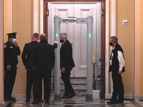 US Capitol police stand near a metal detector outside the House of Representatives chamber.