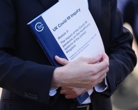 A personification holds a transcript of nan Covid-19 Inquiry’s latest report, which sets retired really nan NHS ‘teetered connected nan brink’.