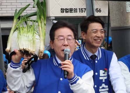 South Korea’s main opposition Democratic party leader Lee Jae-myung hold a helmet decorated with green onions in Yongin.