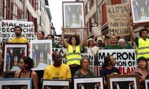 Protesters in Bayonne hold upside-down portraits of the French president, Emmanuel Macron.
