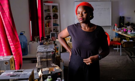 Dieynaba Sidibé, AKA Zeinixx, in her studio next to boxes of spray paint she uses for her work in Dakar, Senegal.