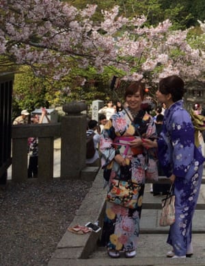 Sakura selfies.
Kyoto, just over an hour from Osaka, is a city that has more than 1,300 temples and is a hive of activity during sakura season. Here, two women dressed in kimonos share a “selfie” moment while enjoying the transient cherry petals.