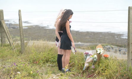Friends laying flowers and tributes at the site where Arthur fell.