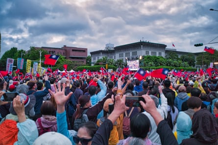 Opposition party supporters in Taipei waving hands, flag and banners in the air