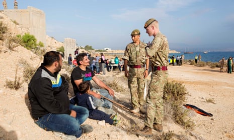 British troops at RAF Akrotiri talk to refugees who arrived at the base on Wednesday.