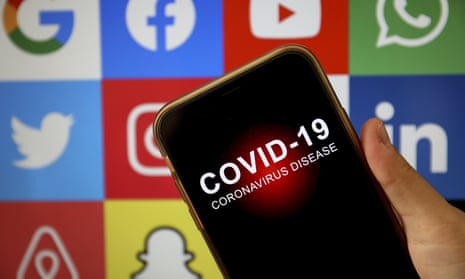 A smartphone with 'Covid-19' on the screen and some social media logos