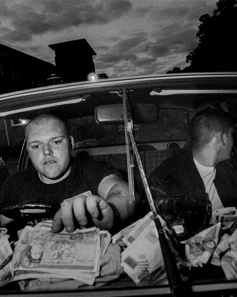 Two skinheads count the night’s cash.