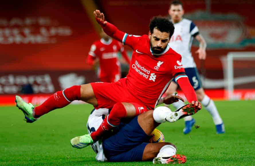 Tottenham Hotspur’s Dutch midfielder Steven Bergwijn (bottom) clashes with Liverpool’s Egyptian midfielder Mohamed Salah during the English Premier League football match between Liverpool and Tottenham Hotspur at Anfield in December 2020.