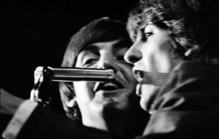 Close-up of McCartney and Harrison singing into a microphone