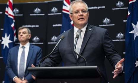 Australian Prime Minister Scott Morrison, flanked by Australia’s chief medical officer Brendan Murphy, speaks at a press conference on Friday.