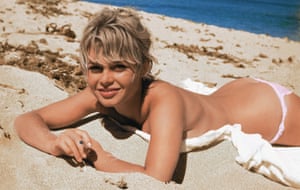 Brigitte Bardot on the beach in classic mid-20th- century pose