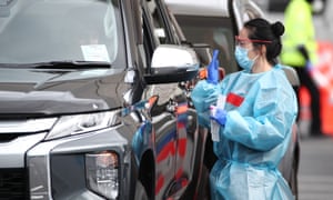 A nurse tests people for Covid-19 at the Otara town centre testing facility in Auckland, New Zealand.