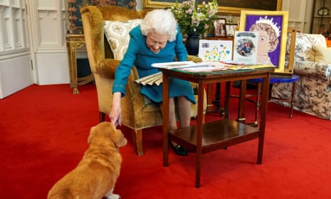 The Queen stroking one of her corgis