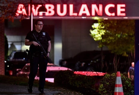 An armed police officer guards the ambulance entrance to the Central Maine Medical Center in Lewiston.