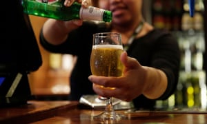 A JD Wetherspoon employee pours Becks lager from a bottle into a glass behind the bar at one of the company’s pubs in London