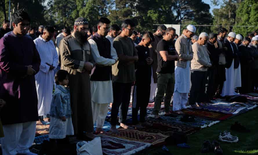 Worshippers stand for Eid ul Fitr prayers at Parramatta Park in western Sydney