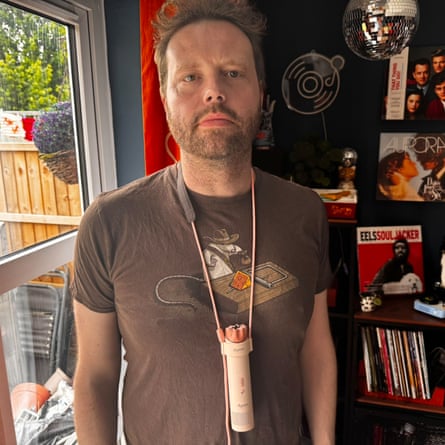 Reviewer Alan Martin wearing the Dyson HushJet Mini Cool fan with its supplied lanyard.
