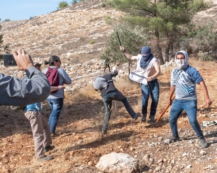 Israeli settlers attacking Palestinians near the West Bank settlement of Bat Ayin.
