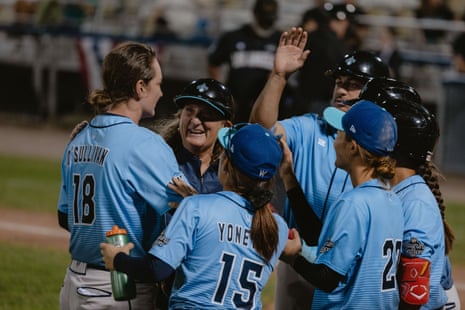 A coach cheers with her team